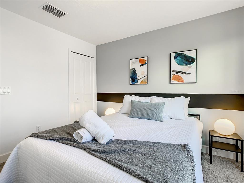 181 Villa Domani Circle Davenport, FL 33896 - Photo 24 of 37 a bedroom with a bed and a couch