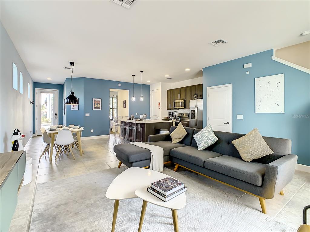 181 Villa Domani Circle Davenport, FL 33896 - Photo 5 of 37 a living room with furniture kitchen view and a table