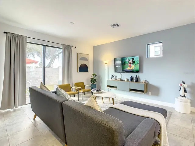 a kitchen with a sink a counter space and living room