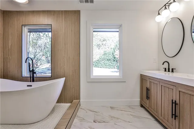 a bathroom with a bathtub and a window