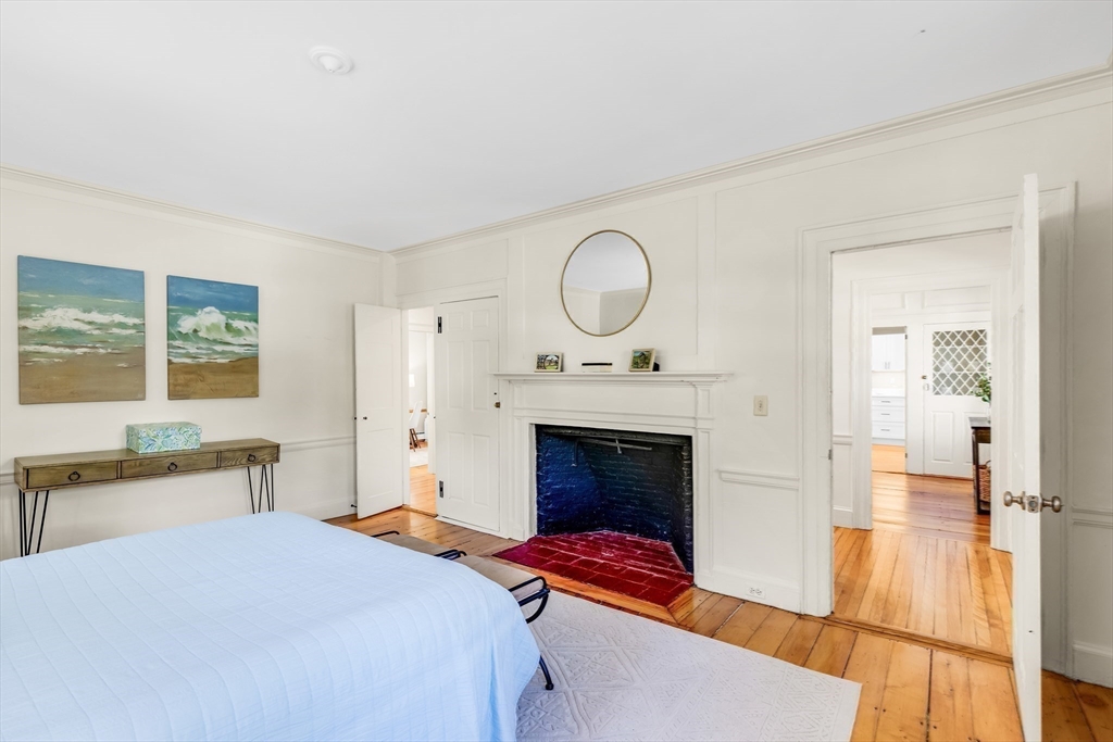 138 State Street, Unit 1 Newburyport, MA 01950 - Photo 23 of 35 a bedroom with a bed and a fireplace