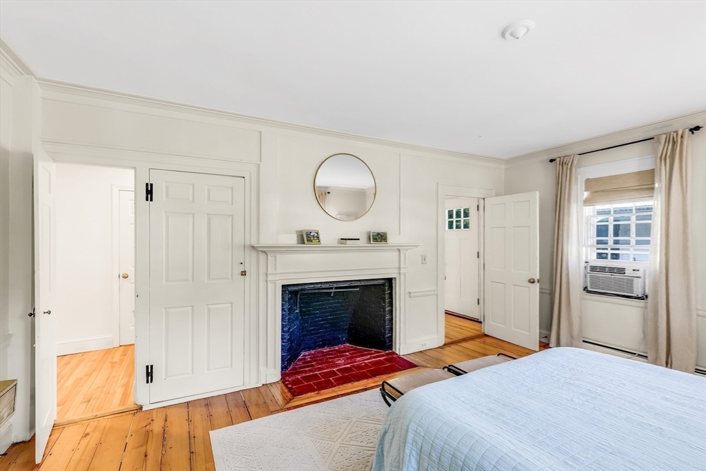 138 State Street, Unit 1 Newburyport, MA 01950 - Photo 24 of 35 a bedroom with a bed and a fireplace