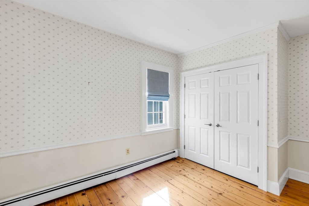 138 State Street, Unit 1 Newburyport, MA 01950 - Photo 27 of 35 a view of an empty room with wooden floor