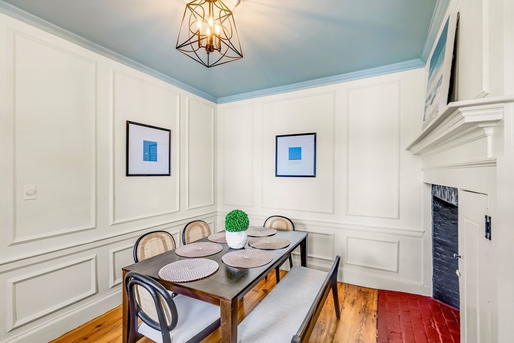138 State Street, Unit 1 Newburyport, MA 01950 - Photo 5 of 35 a view of a dining room with furniture a chandelier and wooden floor