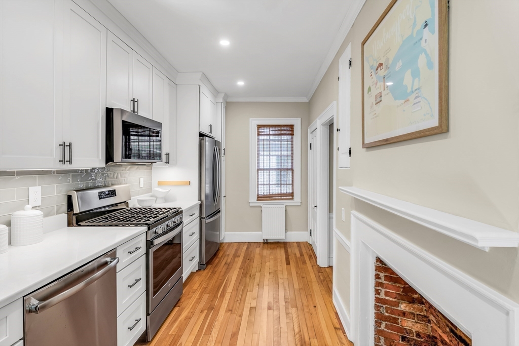 138 State Street, Unit 1 Newburyport, MA 01950 - Photo 9 of 35 a kitchen with stainless steel appliances a stove a sink and a refrigerator