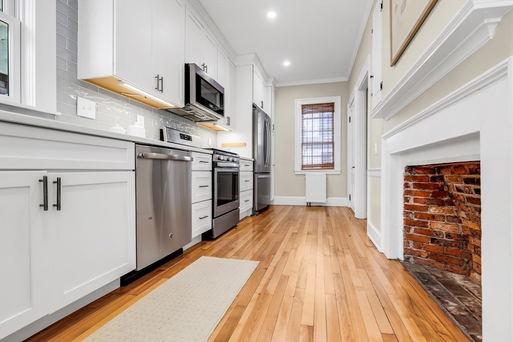 138 State Street, Unit 1 Newburyport, MA 01950 - Photo 10 of 35 a view of a kitchen with wooden floor and electronic appliances