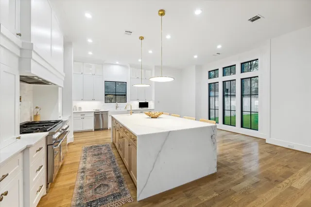 a kitchen with a stove and a wooden floors