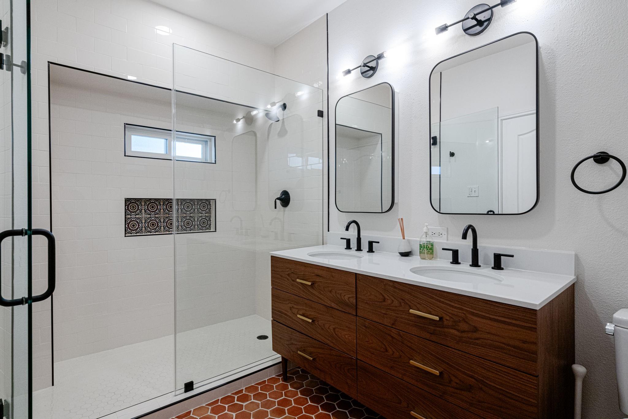 72 San Saba Street Austin, TX 78702 - Photo 12 of 23 Full bathroom featuring double vanity and a stall shower
