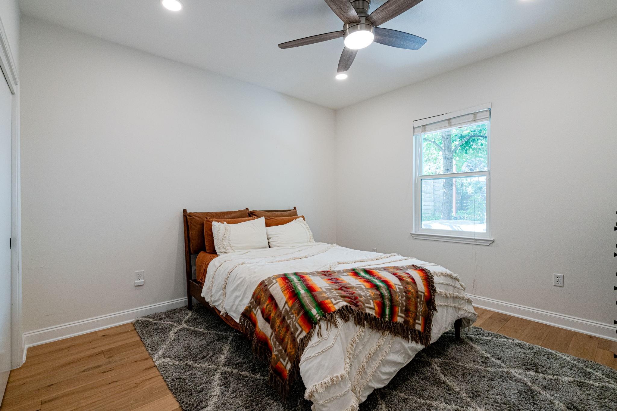 72 San Saba Street Austin, TX 78702 - Photo 16 of 23 Bedroom with light wood-style floors, ceiling fan, and recessed lighting