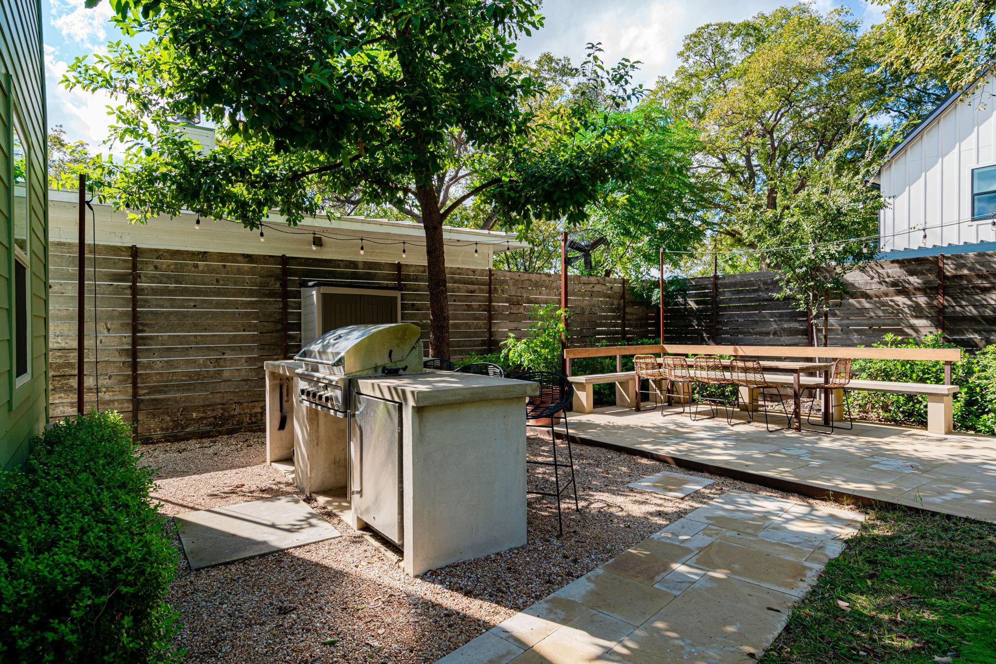 72 San Saba Street Austin, TX 78702 - Photo 18 of 23 Fenced backyard featuring a patio area and an outdoor kitchen / dining area