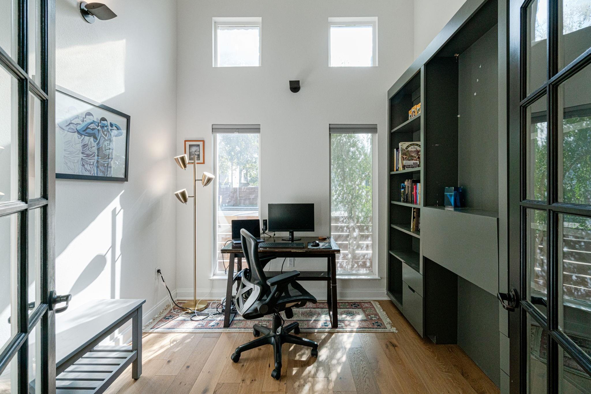 72 San Saba Street Austin, TX 78702 - Photo 9 of 23 Home office featuring light wood finished floors, a high ceiling, and french doors