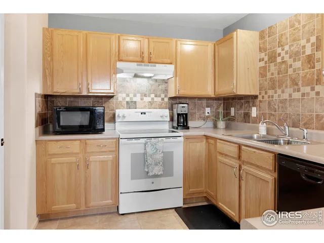 a kitchen with stainless steel appliances a refrigerator sink and cabinets