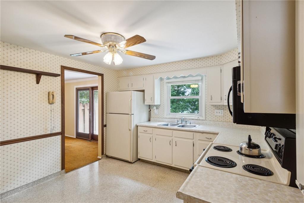 211 Wyngate Road Coraopolis, PA 15108 - Photo 13 of 31 a kitchen with a sink a stove and a refrigerator
