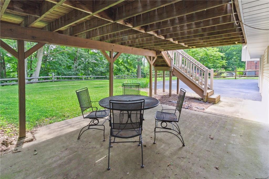 211 Wyngate Road Coraopolis, PA 15108 - Photo 29 of 31 a view of a patio with table and chairs next to a yard with wooden fence