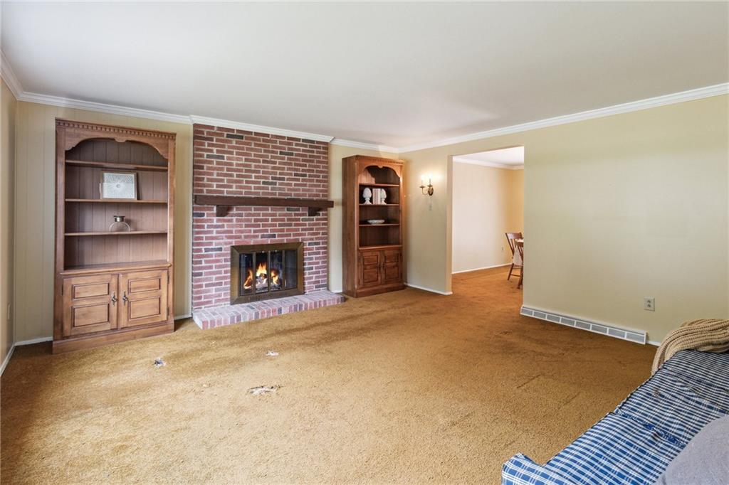 211 Wyngate Road Coraopolis, PA 15108 - Photo 5 of 31 a view of an empty room with a fireplace and a window