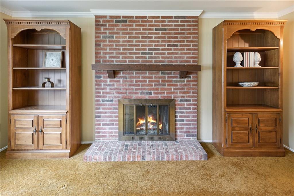 211 Wyngate Road Coraopolis, PA 15108 - Photo 8 of 31 a living room with a fireplace and a walk in closet