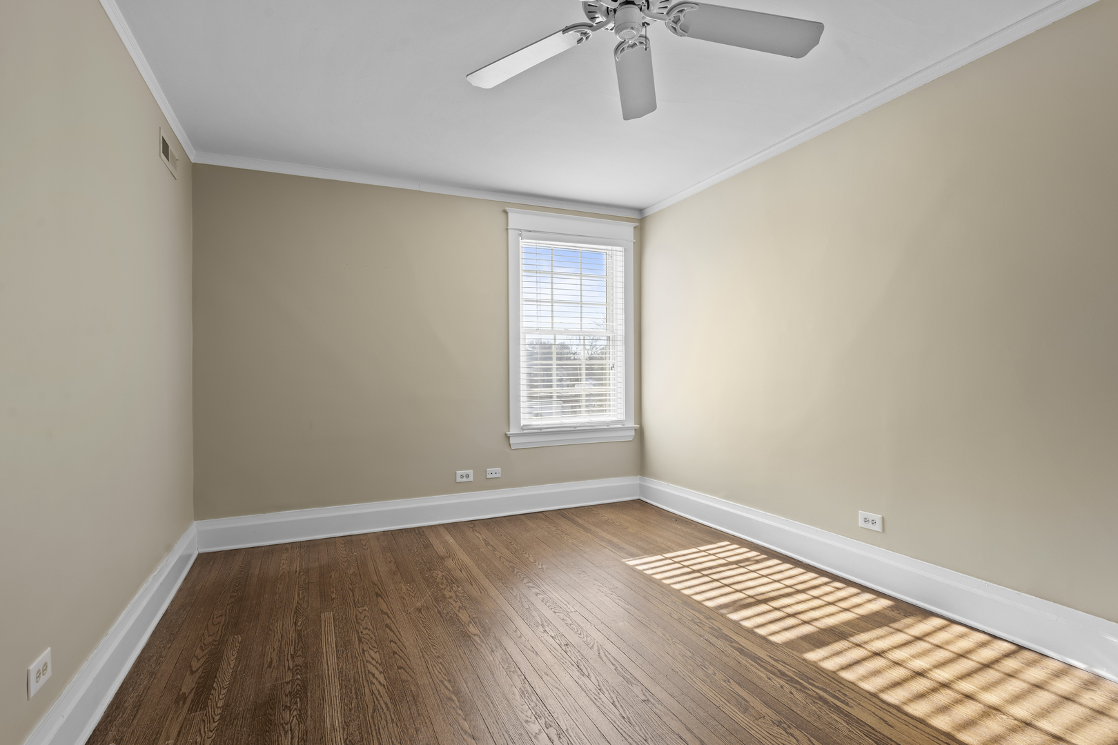 399 East Deerpath Road Lake Forest, IL 60045 - Photo 48 of 61 a view of an empty room with wooden floor and a window