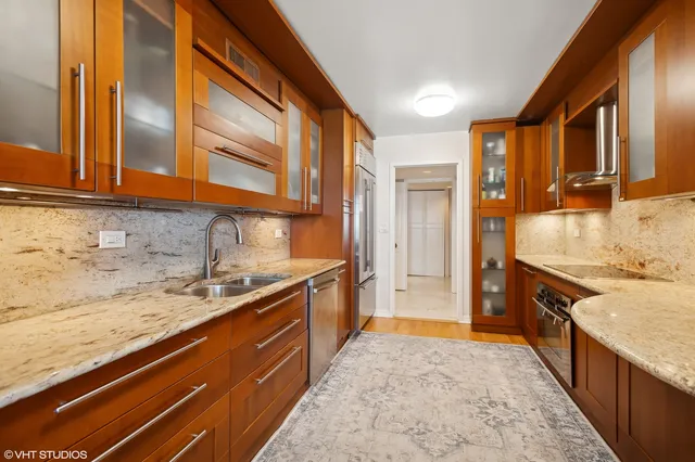 a large kitchen with stainless steel appliances granite countertop a granite counter tops and a stove