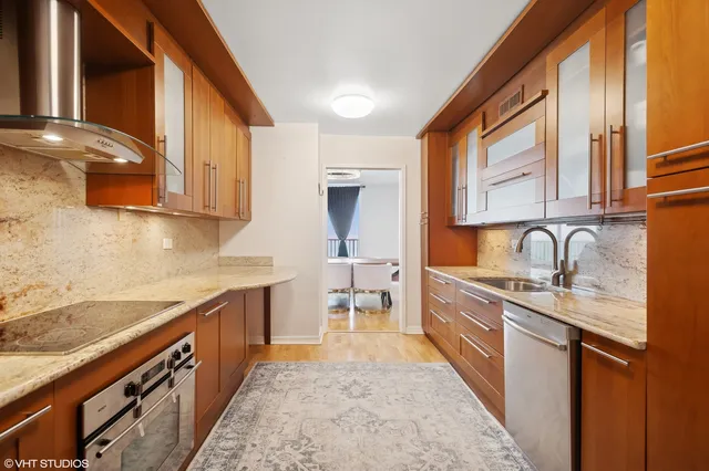 a kitchen with stainless steel appliances granite countertop a sink and cabinets