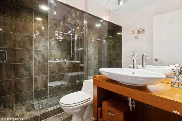a bathroom with a sink toilet and shower