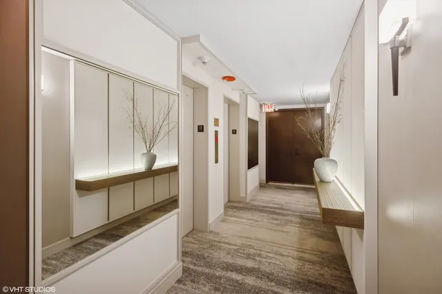 a view of a hallway with wooden floor and entryway