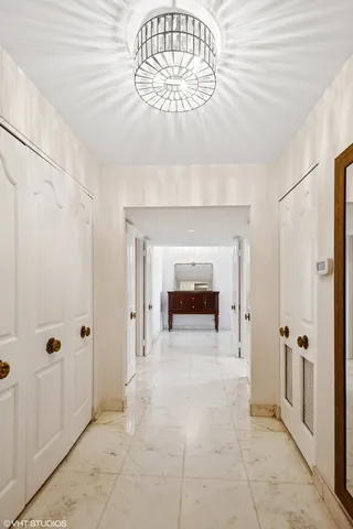 a view of a hallway with a chandelier