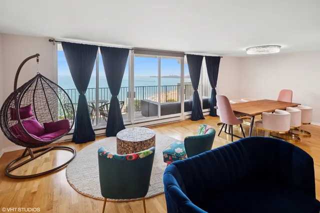 a living room with furniture a window and a chandelier