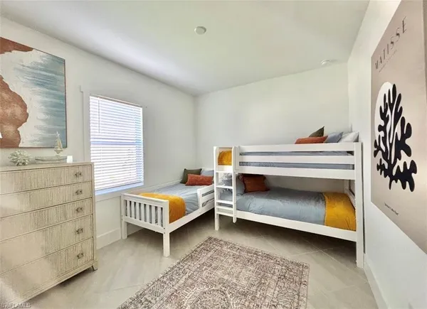 a bedroom with two bunk beds and a window