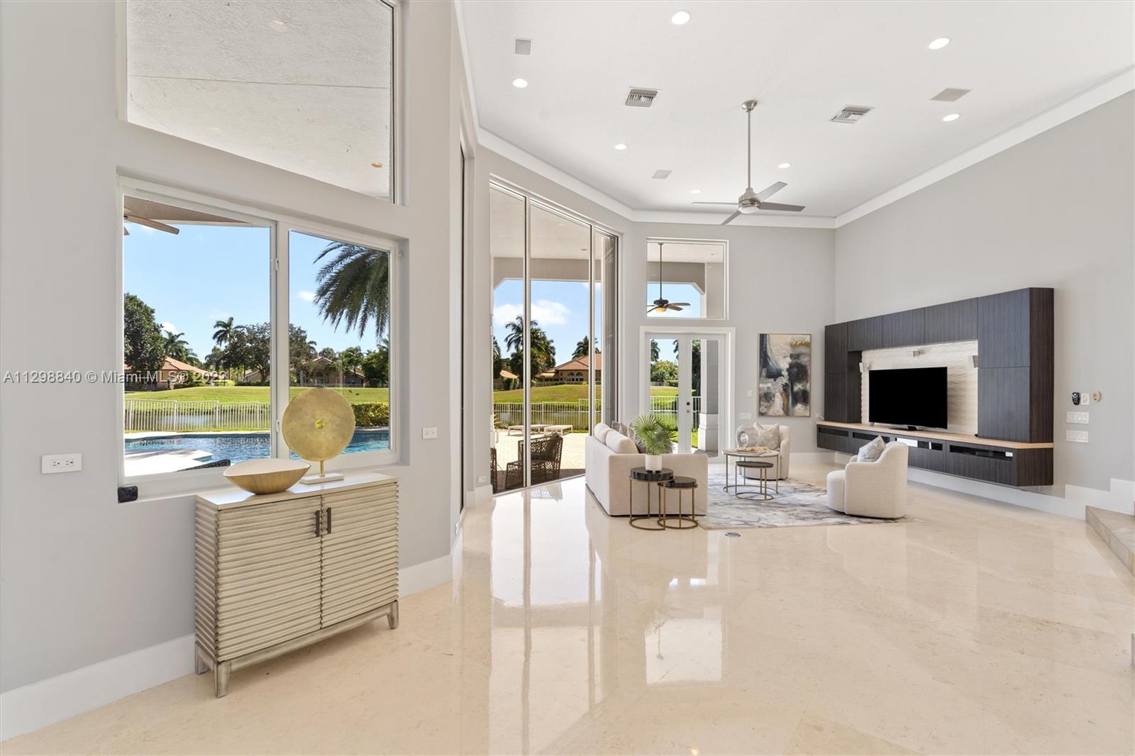 3088 Birkdale Drive Weston, FL 33332 - Photo 15 of 51 a view of a living room and kitchen floor to ceiling windows