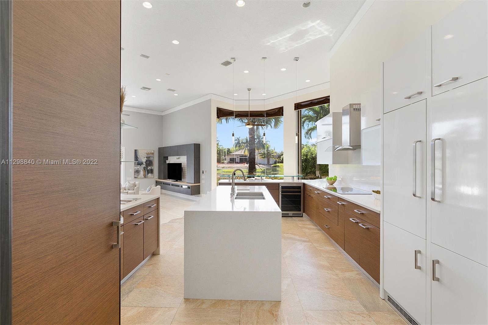 3088 Birkdale Drive Weston, FL 33332 - Photo 22 of 51 a large kitchen with kitchen island a large counter top space a sink stainless steel appliances and cabinets