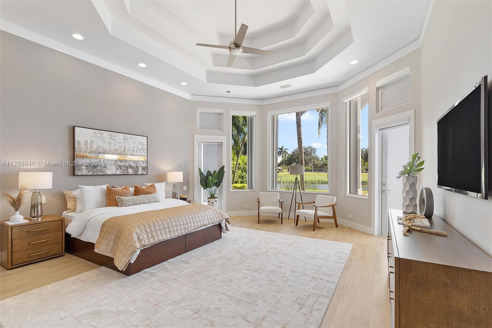 3088 Birkdale Drive Weston, FL 33332 - Photo 23 of 51 a bedroom with a large bed a flat screen tv and a large window