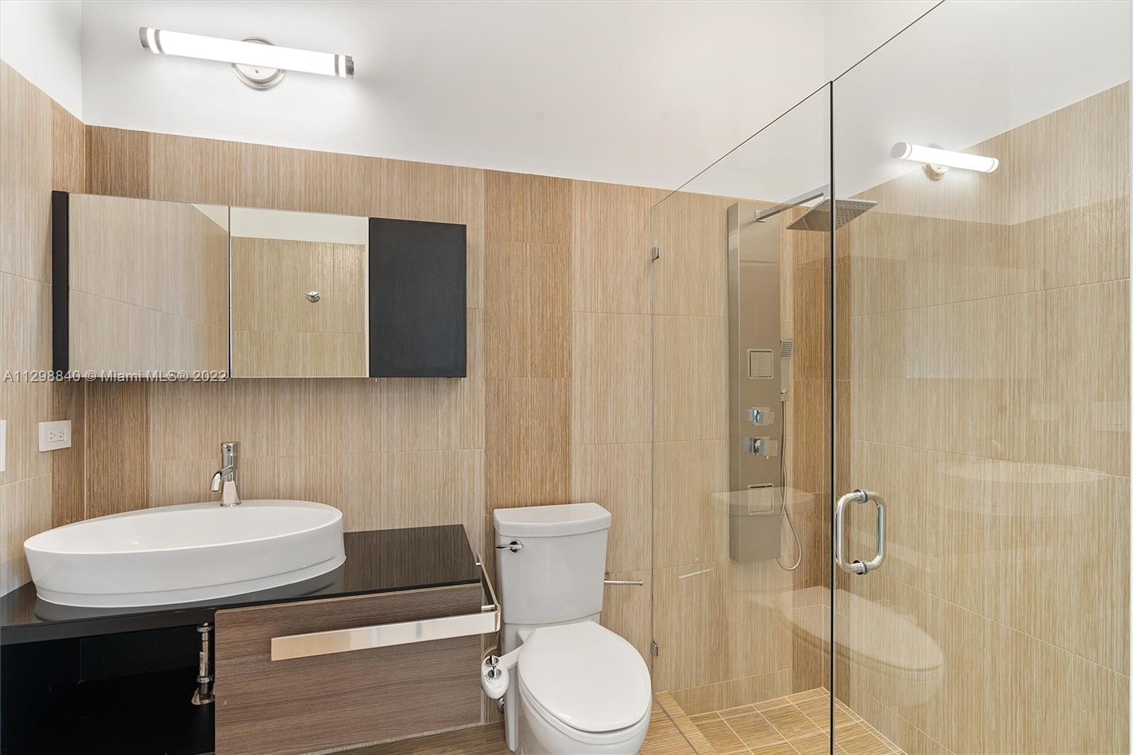 3088 Birkdale Drive Weston, FL 33332 - Photo 31 of 51 a bathroom with a sink a toilet a mirror and shower