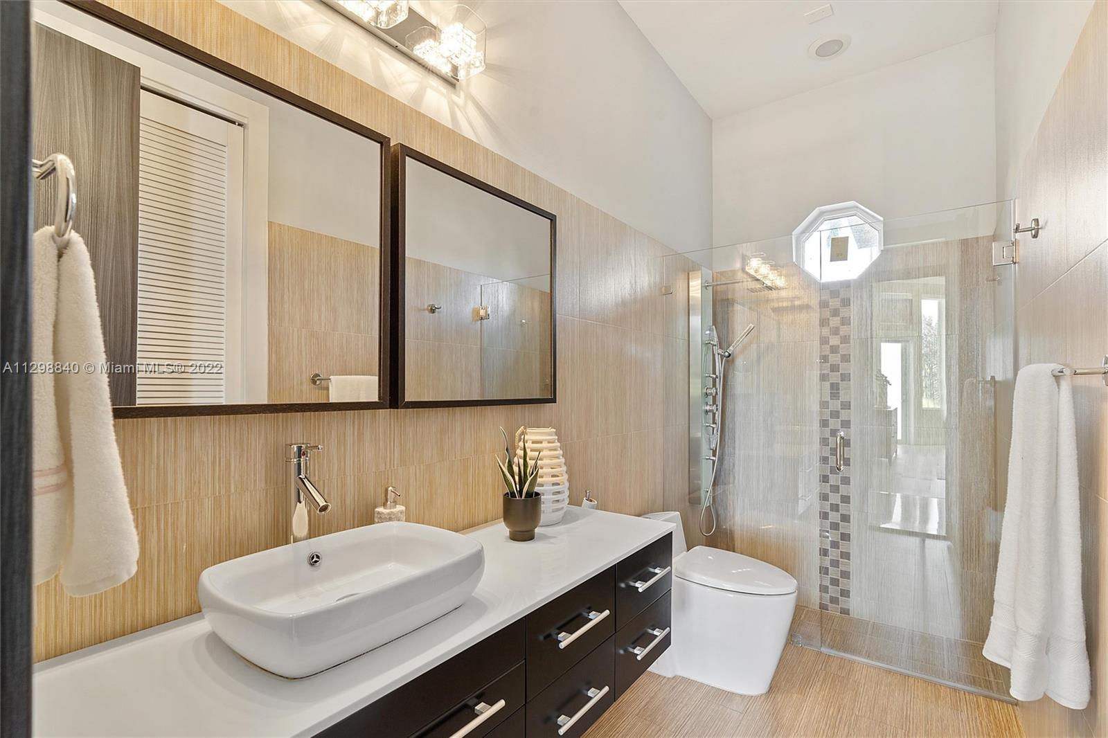 3088 Birkdale Drive Weston, FL 33332 - Photo 34 of 51 a bathroom with a sink a toilet and a mirror