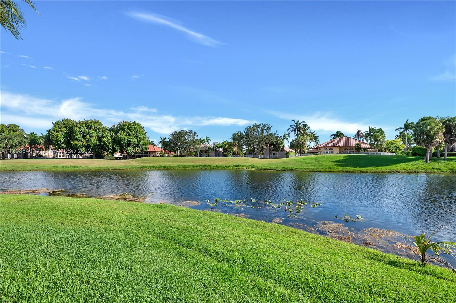 3088 Birkdale Drive Weston, FL 33332 - Photo 39 of 51 a view of a lake with houses in the back
