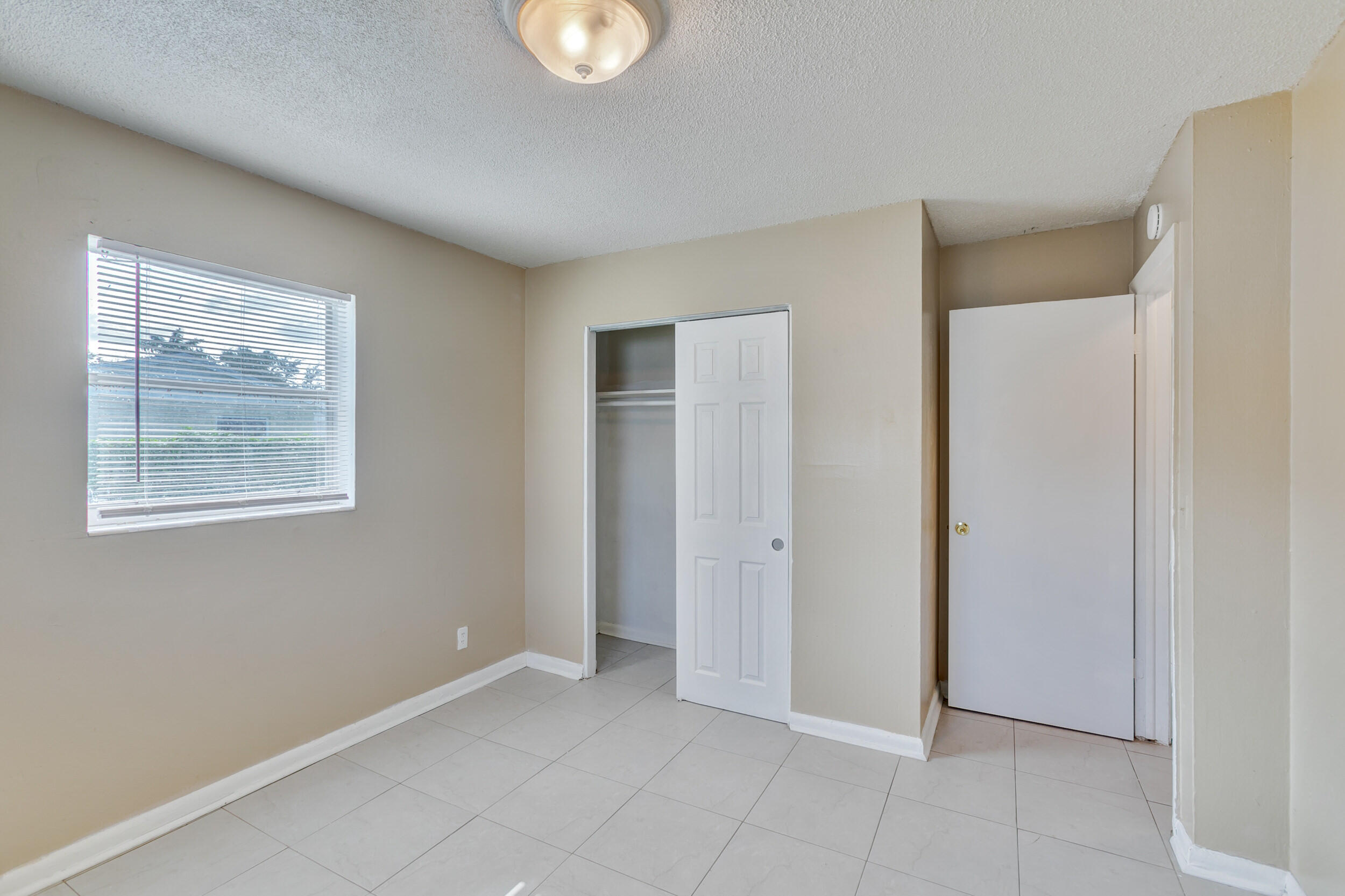 451 Silver Beach Road, Unit 1 Riviera Beach, FL 33403 - Photo 26 of 29 a view of an empty room with a window