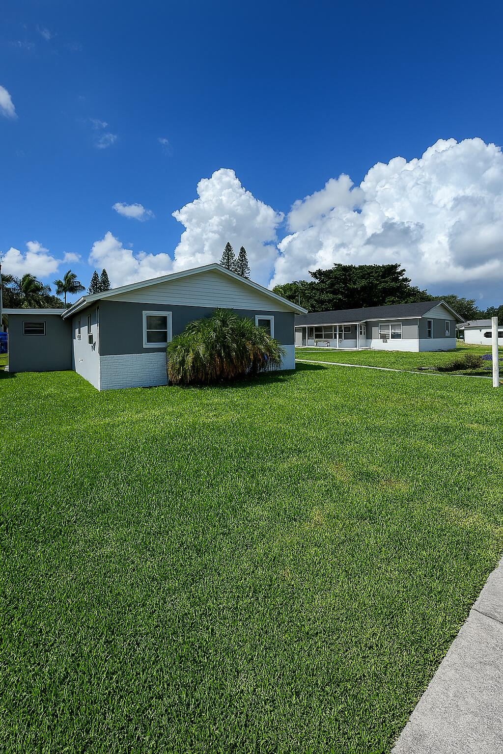 451 Silver Beach Road, Unit 1 Riviera Beach, FL 33403 - Photo 5 of 29 a view of a house with a yard