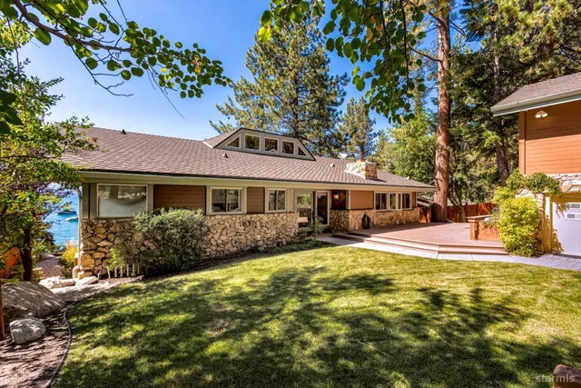 a front view of a house with yard porch and outdoor seating