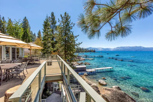 a view of a house with pool and sitting area