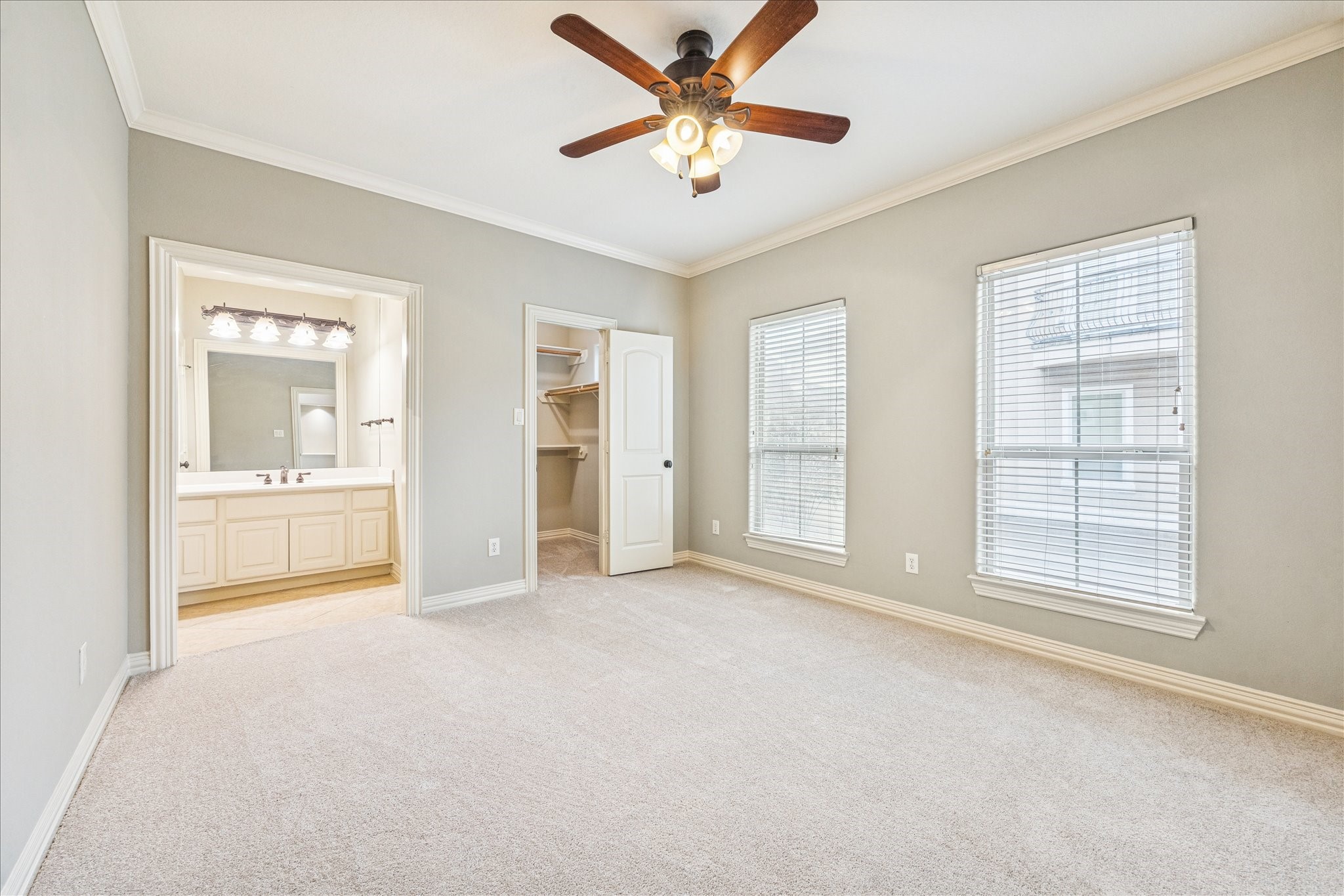 2 Schwab Lane Houston, TX 77055 - Photo 12 of 27 an empty room with chandelier fan and windows