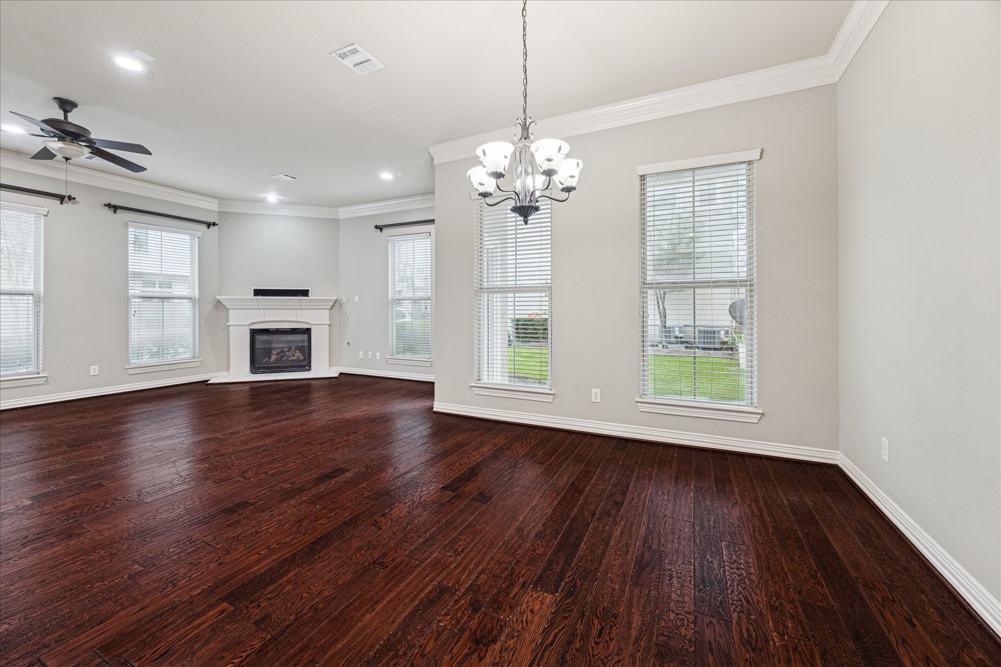 2 Schwab Lane Houston, TX 77055 - Photo 10 of 27 a view of an empty room with wooden floor and a window