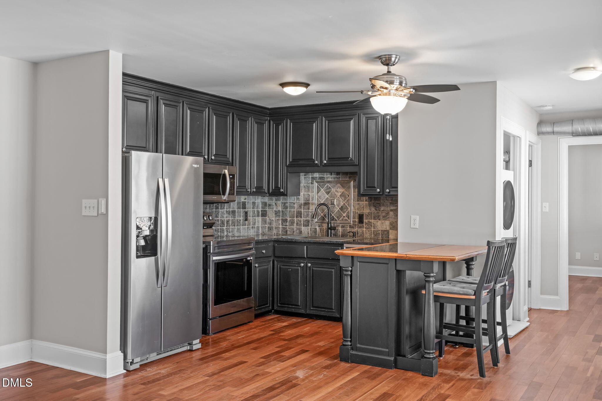 2208 Stafford Avenue Raleigh, NC 27607 - Photo 7 of 30 a kitchen with stainless steel appliances granite countertop a refrigerator a sink dishwasher a stove and a dining table with wooden floor
