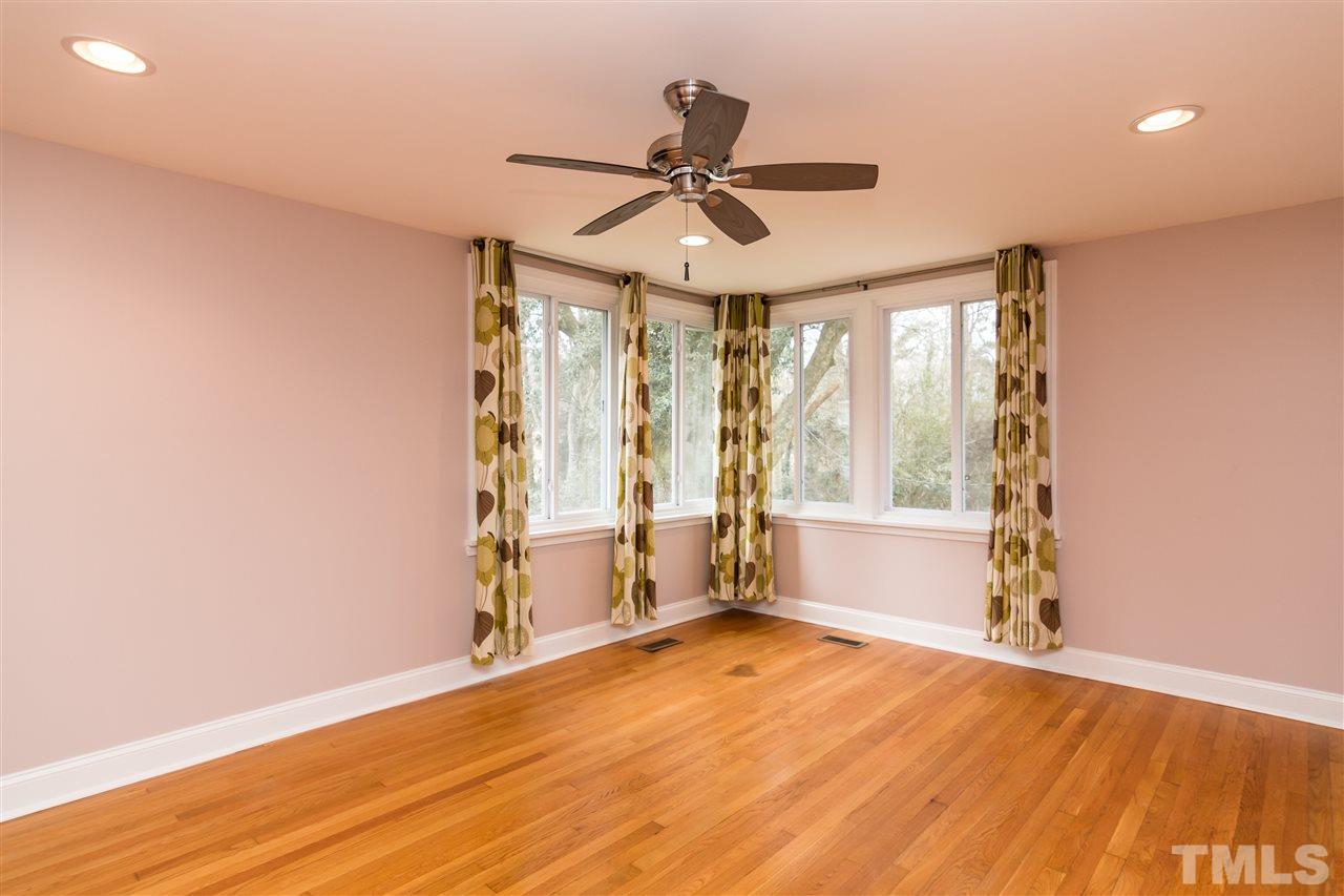 107 King William Road Raleigh, NC 27610 - Photo 11 of 25 an empty room with wooden floor fan and windows