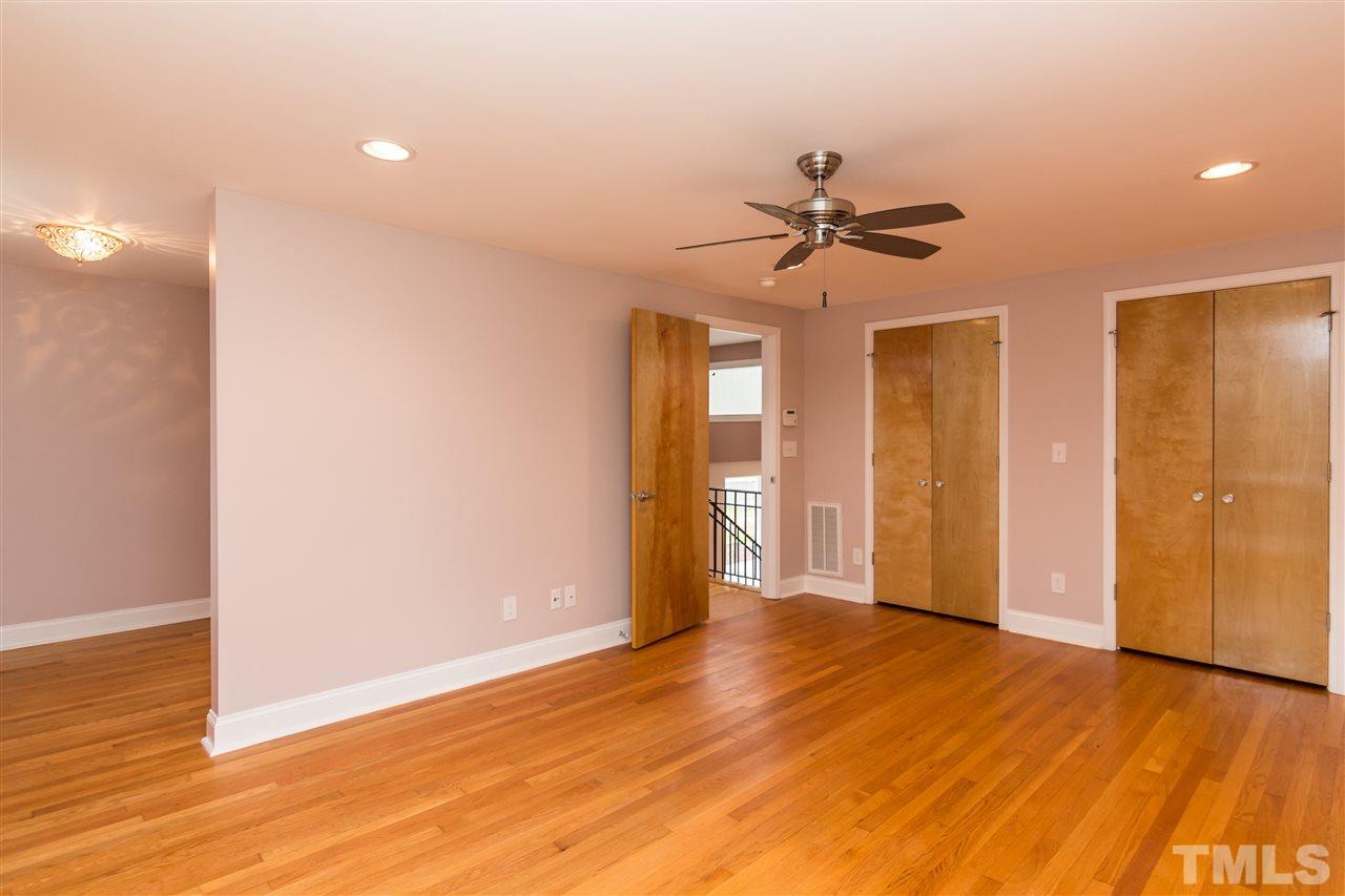 107 King William Road Raleigh, NC 27610 - Photo 14 of 25 a view of a big room with wooden floor and a chandelier fan