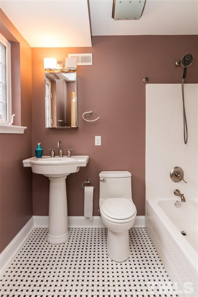 107 King William Road Raleigh, NC 27610 - Photo 17 of 25 a bathroom with a sink toilet a mirror and shower