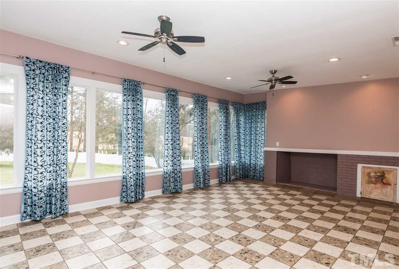 107 King William Road Raleigh, NC 27610 - Photo 6 of 25 a bedroom with a bed and a chandelier