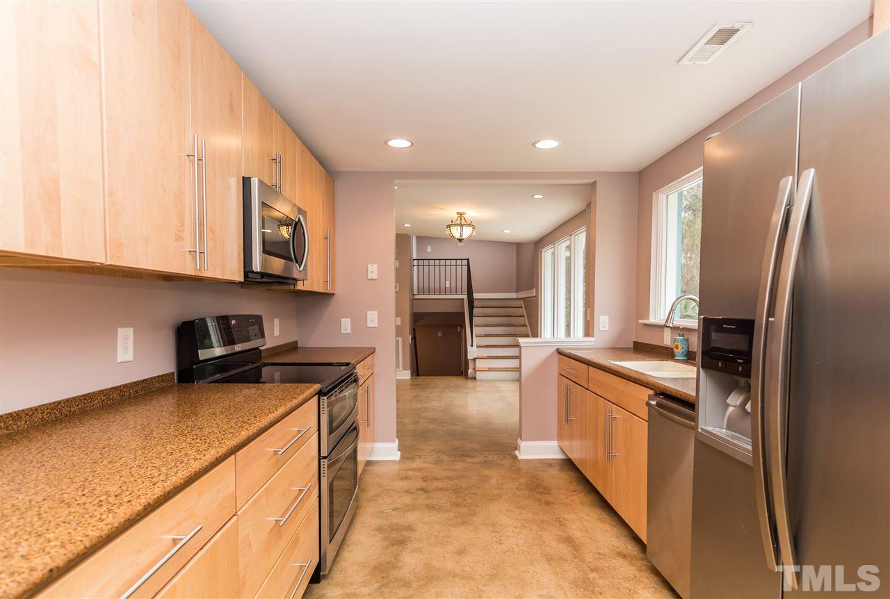 107 King William Road Raleigh, NC 27610 - Photo 10 of 25 a large kitchen with stainless steel appliances granite countertop a stove a sink and a refrigerator