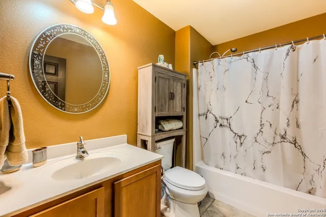 a view of a livingroom with furniture and a fan