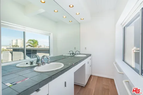 a bathroom with a granite countertop sink and a mirror