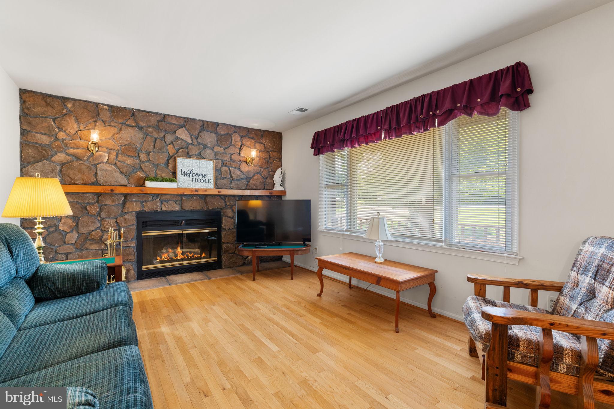 161 Troy Road Louisa, VA 23093 - Photo 6 of 60 a living room with furniture a fireplace and a table