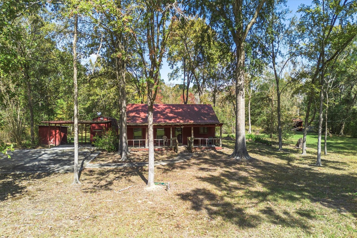 22868 Henson Road Montgomery, TX 77356 - Photo 4 of 9 a view of a barn with a large tree
